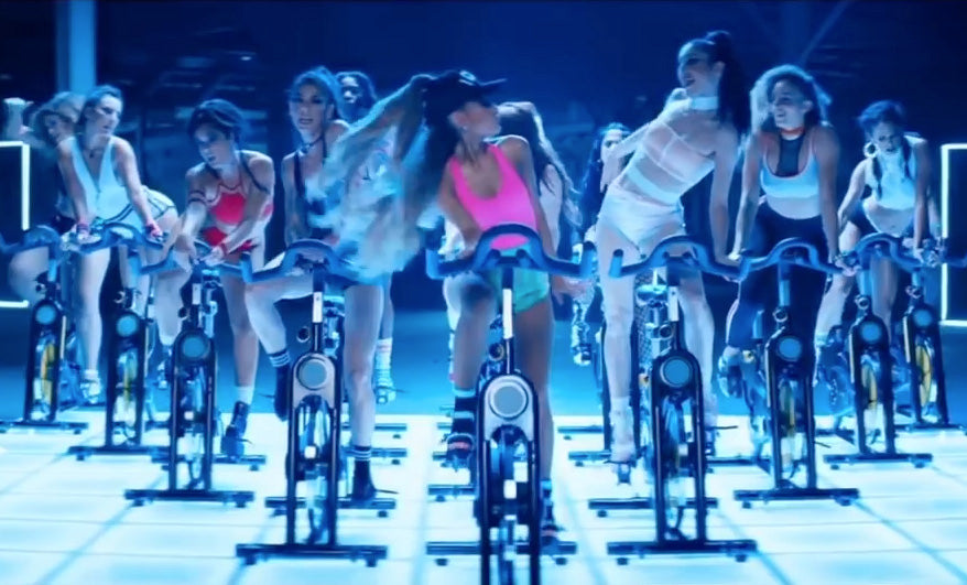 Women in a cycling class wearing bikinis and activewear